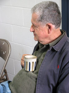 Older man holding a coffee cup