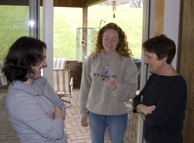 Patti, her daughter Kate, and Adrienne Leppold with a hummingbird