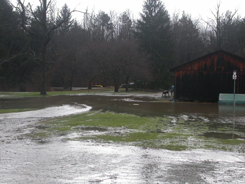 Flooded grass area around barn
