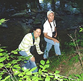 Man and woman (researchers) at a creek's edge