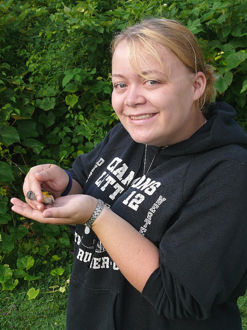 A woman holding a bird