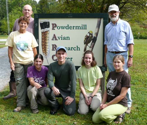 workshop participants gathered around the Powdermill Avian Research Center sign