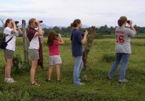 People with binoculars watching for birds